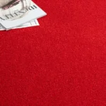 Bright red carpet with a magazine on top