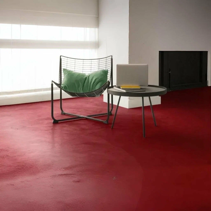 Industrial matte red epoxy floor in a minimalist workspace