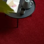 Red plush carpet with a black coffee table