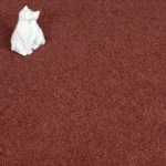 Red plush carpet with small white cat statues