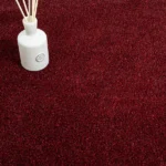 Red ribbed carpet with a white ceramic bird