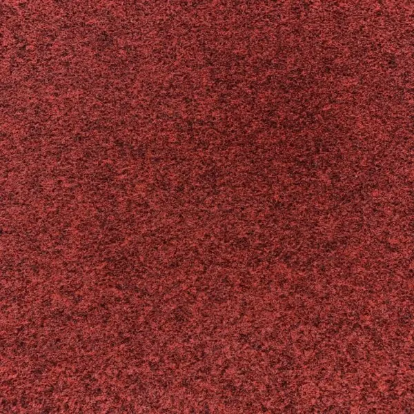 Speckled red granite surface with black and brown flecks