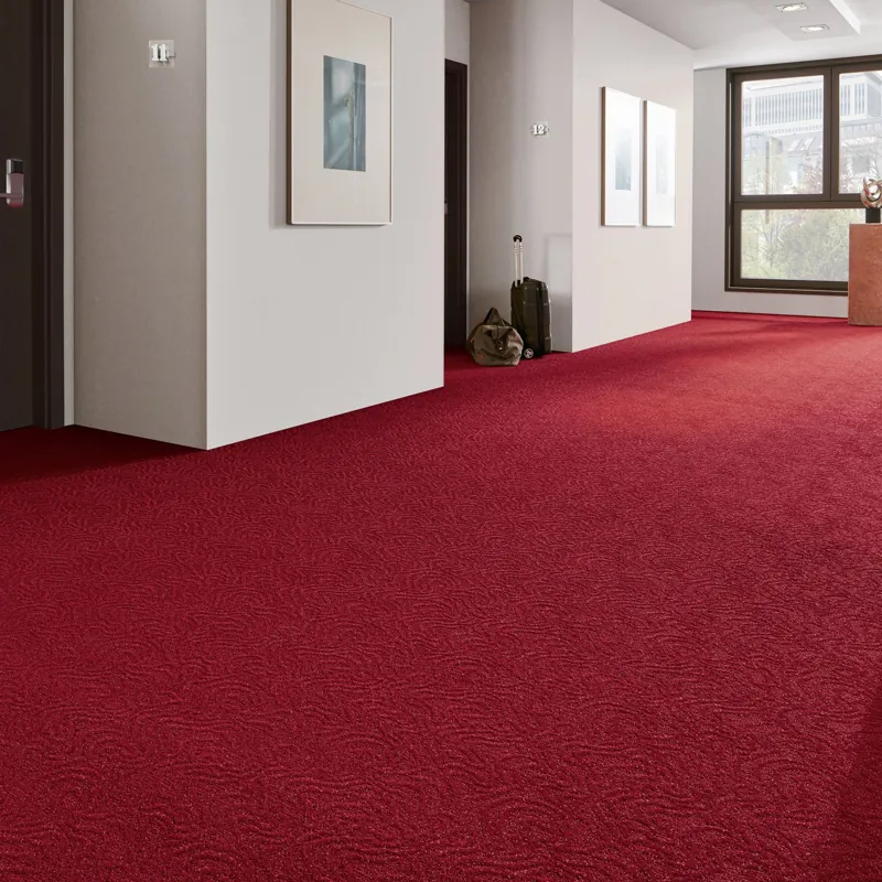 crimson patterned hallway carpet in a high-end hotel corridor.